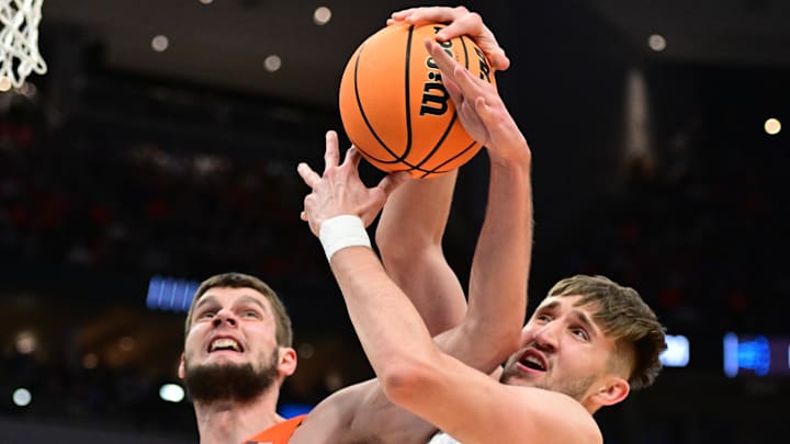 Mar 23, 2025; Milwaukee, WI, USA;  Illinois Fighting Illini center Tomislav Ivisic (13) and Kentucky Wildcats forward Andrew Carr (7) go for a rebound during the first half in the second round of the NCAA Tournament at Fiserv Forum. Mandatory Credit: Benny Sieu-Imagn Images