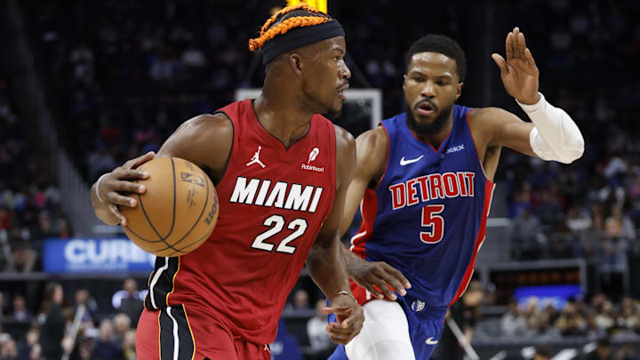 Dec 16, 2024; Detroit, Michigan, USA;  Miami Heat forward Jimmy Butler (22) dribbles as Detroit Pistons guard Malik Beasley (5) defends in the first half at Little Caesars Arena. Mandatory Credit: Rick Osentoski-Imagn Images