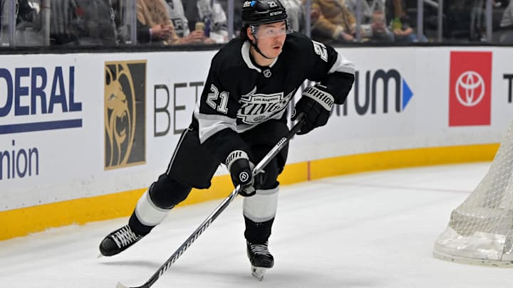 Apr 23, 2025; Los Angeles, California, USA; Los Angeles Kings defenseman Jordan Spence (21) handles the puck during game 2 of the 2025 Stanley Cup Playoffs against the Edmonton Oilers at Crypto.com Arena. Mandatory Credit: Jayne Kamin-Oncea-Imagn Images