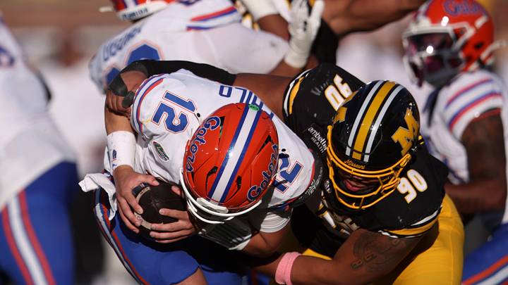Oct 3, 2026; Columbia, Missouri, USA;  Missouri Tigers defensive tackle Sterling Webb (90) sacks Florida Gators quarterback Aaron Philo (12) in the fourth quarter at Faurot Field at Memorial Stadium.  Mandatory Credit: William Purnell-Imagn Images