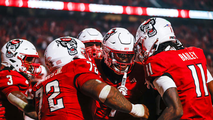 Nov 21, 2025; Raleigh, North Carolina, USA; NC State Wolfpack tight end Justin Joly (7) celebrates his touchdown to win the game during the second half of the game against Florida State Seminoles at Carter-Finley Stadium. Mandatory Credit: Jaylynn Nash-Imagn Images Nov 21, 2025; Raleigh, North Carolina, USA; NC State Wolfpack tight end Justin Joly (7) celebrates his touchdown to win the game during the second half of the game against Florida State Seminoles at Carter-Finley Stadium. Mandatory Credit: Jaylynn Nash-Imagn Images