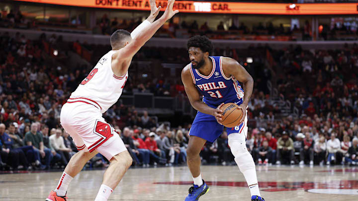 Dec 8, 2024; Chicago, Illinois, USA; Chicago Bulls center Nikola Vucevic (9) defends against Philadelphia 76ers center Joel Embiid (21) during the second half at United Center. Mandatory Credit: Kamil Krzaczynski-Imagn Images