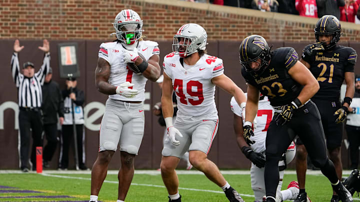 Ohio State Buckeyes running back Quinshon Judkins (1) celebrates a touchdown with tight end Patrick Gurd (49) beside Northwestern Wildcats linebacker Braydon Brus (33) during the first half of the NCAA football game at Wrigley Field in Chicago on Saturday, Nov. 16, 2024.