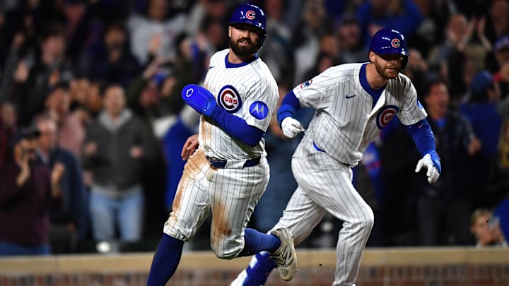May 27, 2025; Chicago, Illinois, USA; Chicago Cubs pinch runner Jon Berti (5) celebrates with catcher Carson Kelly (15) after scoring the game winning run during the eleventh inning against the Colorado Rockies at Wrigley Field. Mandatory Credit: Patrick Gorski-Imagn Images