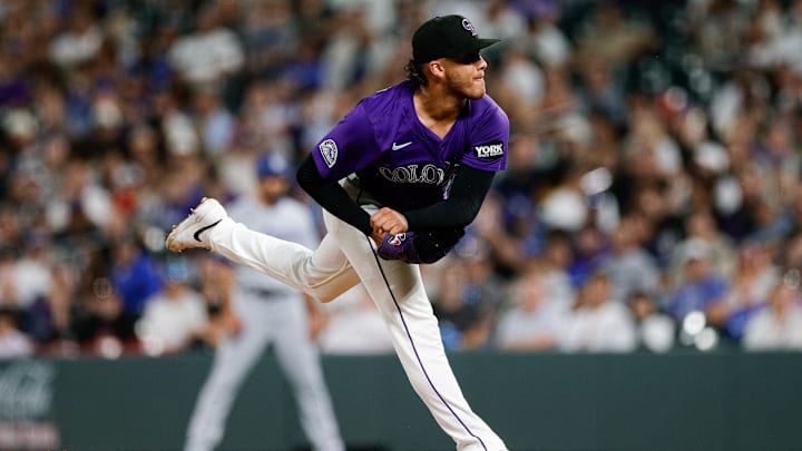 Aug 18, 2025; Denver, Colorado, USA; Colorado Rockies relief pitcher Luis Peralta (41) pitches in the seventh inning against the Los Angeles Dodgers at Coors Field. Mandatory Credit: Isaiah J. Downing-Imagn Images