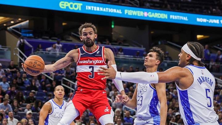 Mar 12, 2026; Orlando, Florida, USA; Washington Wizards guard Trae Young (3) passes the ball in front of Orlando Magic forward Tristan da Silva (23) and forward Paolo Banchero (5) during the first quarter at Kia Center. Mandatory Credit: Mike Watters-Imagn Images