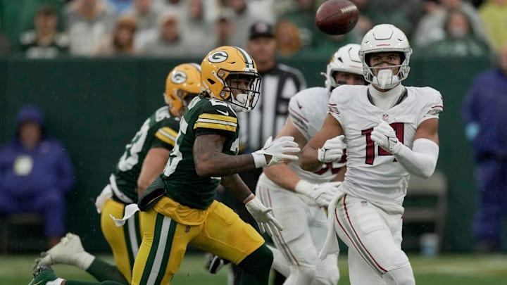 FIRST OF A SERIES — Green Bay Packers cornerback Keisean Nixon (25) breaks up a pass intended for Arizona Cardinals wide receiver Michael Wilson (14) during the first quarter of their game Sunday, October 13, 2024 at Lambeau Field in Green Bay, Wisconsin.
