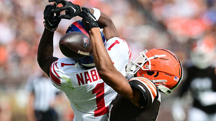 Sep 22, 2024; Cleveland, Ohio, USA; Cleveland Browns cornerback Greg Newsome II (0) breaks up a pass intended for New York Giants wide receiver Malik Nabers (1) during the second half at Huntington Bank Field. Mandatory Credit: Ken Blaze-Imagn Images