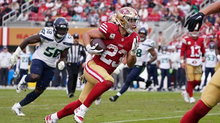 Nov 17, 2024; Santa Clara, California, USA; San Francisco 49ers running back Christian McCaffrey (23) rushes the ball while be pursued by Seattle Seahawks linebacker Derick Hall (58) in the fourth quarter at Levi's Stadium. Mandatory Credit: David Gonzales-Imagn Images Nov 17, 2024; Santa Clara, California, USA; San Francisco 49ers running back Christian McCaffrey (23) rushes the ball while be pursued by Seattle Seahawks linebacker Derick Hall (58) in the fourth quarter at Levi's Stadium. Mandatory Credit: David Gonzales-Imagn Images