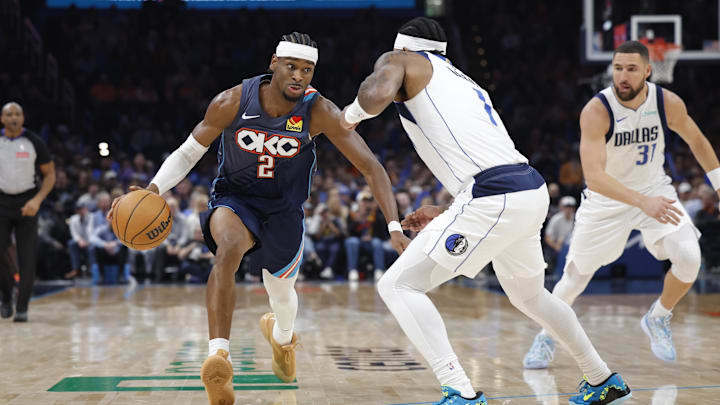 Dec 5, 2025; Oklahoma City, Oklahoma, USA; Oklahoma City Thunder guard Shai Gilgeous-Alexander (2) drives past Dallas Mavericks guard Jaden Hardy (1) during the second half at Paycom Center. Mandatory Credit: Alonzo Adams-Imagn Images