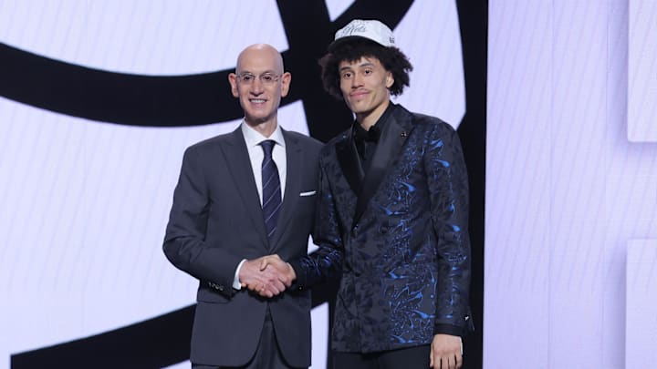 Jun 25, 2025; Brooklyn, NY, USA; Nolan Traore stands with NBA commissioner Adam Silver after being selected as the 19th pick by the Brooklyn Nets in the first round of the 2025 NBA Draft at Barclays Center. Mandatory Credit: Brad Penner-Imagn Images Jun 25, 2025; Brooklyn, NY, USA; Nolan Traore stands with NBA commissioner Adam Silver after being selected as the 19th pick by the Brooklyn Nets in the first round of the 2025 NBA Draft at Barclays Center. Mandatory Credit: Brad Penner-Imagn Images
