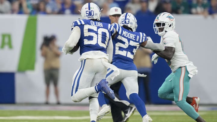 Indianapolis Colts linebacker Segun Olubi (50) rushes the ball after picking up a fumbled ball during a game against the Miami Dolphins at Lucas Oil Stadium.
