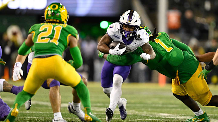 Dec 20, 2025; Eugene, OR, USA;  James Madison Dukes running back Wayne Knight (3) rushes as Oregon Ducks defensive back Aaron Flowers (21) defends during the second quarter at Autzen Stadium. Mandatory Credit: Troy Wayrynen-Imagn Images