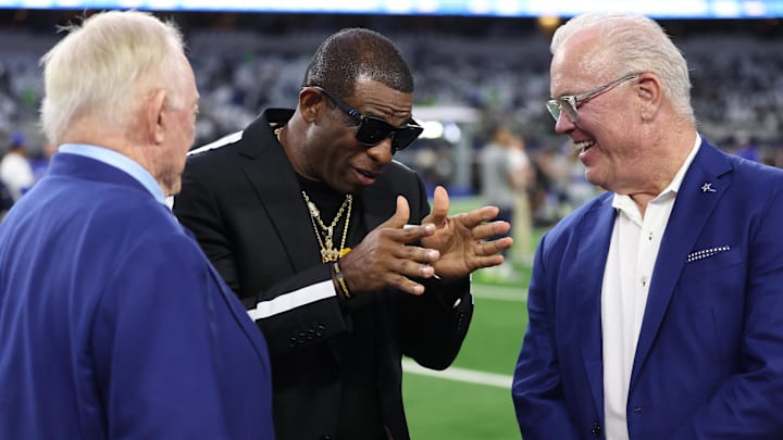 Nov 30, 2023; Arlington, Texas, USA; Colorado Buffaloes head coach Deion Sanders (center) talks with