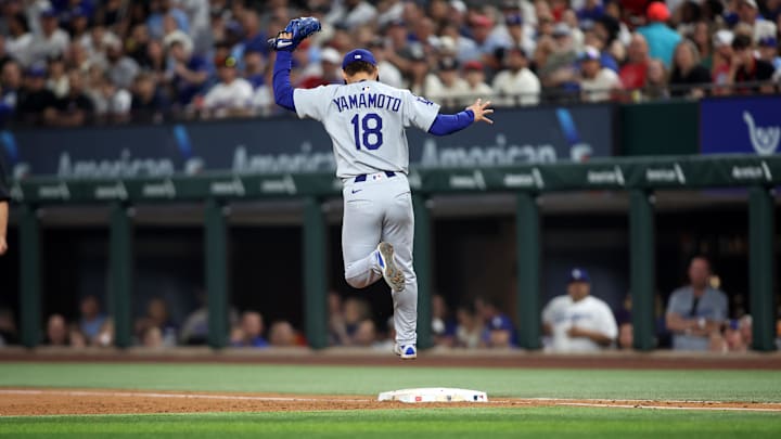 Apr 18, 2025; Arlington, Texas, USA; Los Angeles Dodgers pitcher Yoshinobu Yamamoto (18) makes a put out during the third inning against the Texas Rangers at Globe Life Field. Mandatory Credit: Tim Heitman-Imagn Images