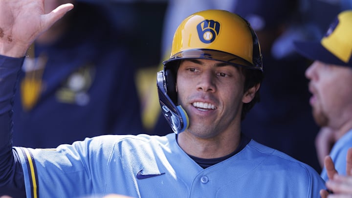 Apr 4, 2026; Kansas City, Missouri, USA; Milwaukee Brewers left fielder Christian Yelich (22) celebrates in the dugout after scoring during the first inning against the Kansas City Royals at Kauffman Stadium. Mandatory Credit: William Purnell-Imagn Images