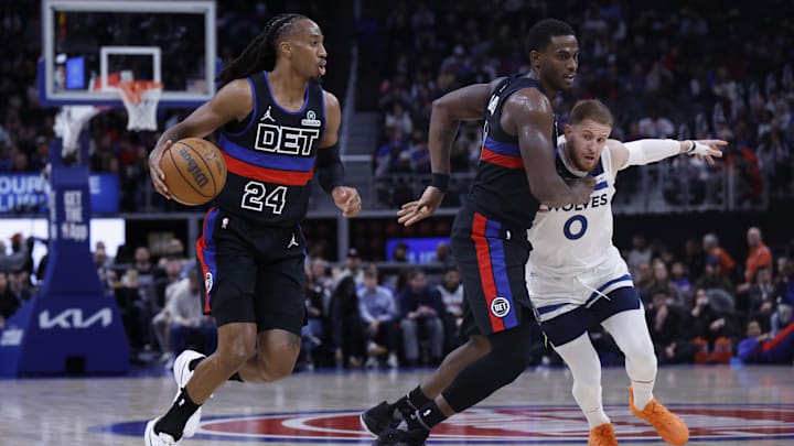 Apr 02, 2026; Detroit, Michigan, USA;  Detroit Pistons guard Daniss Jenkins (24) dribbles against Minnesota Timberwolves guard Donte DiVincenzo (0) in the first half at Little Caesars Arena. Mandatory Credit: Rick Osentoski-Imagn Images