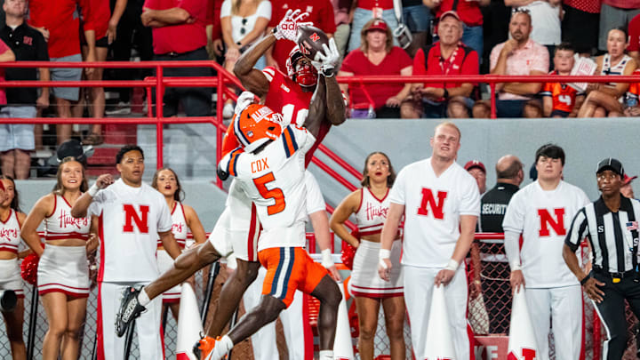 Sep 20, 2024; Lincoln, Nebraska, USA; Illinois Fighting Illini defensive back Torrie Cox Jr. (5) intercepts a pass to Nebraska Cornhuskers wide receiver Isaiah Neyor (18) during the second quarter at Memorial Stadium. Mandatory Credit: Dylan Widger-Imagn Images