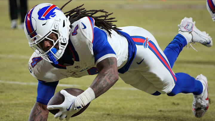 Buffalo Bills running back James Cook (4) dives for a touchdown against the Kansas City Chiefs in the AFC Championship game at GEHA Field at Arrowhead Stadium. 