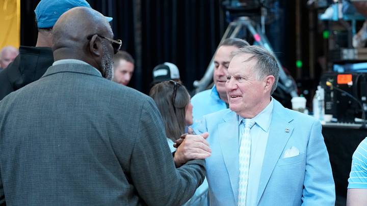 Mar 8, 2025; Chapel Hill, North Carolina, USA;  Former North Carolina Tar Heels great Lawrence Taylor with head football coach Bill Bellichick together during a time out in the first half at Dean E. Smith Center. Mandatory Credit: Bob Donnan-Imagn Images