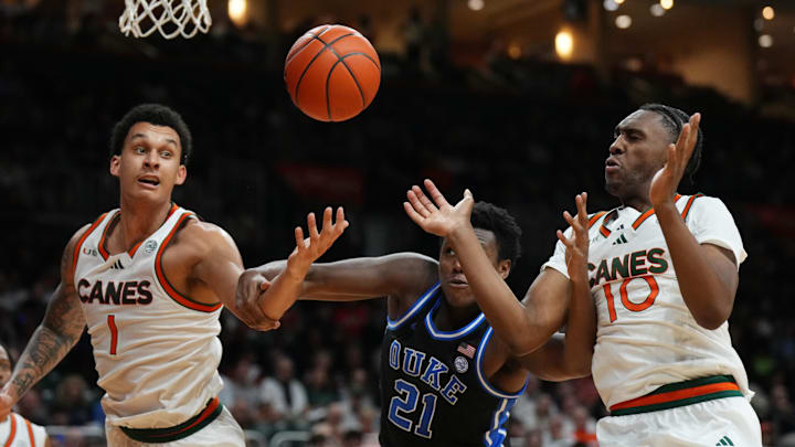 Feb 25, 2025; Coral Gables, Florida, USA;  Miami (Fl) Hurricanes center Lynn Kidd (1), Duke Blue Devils center Patrick Ngongba II (21) and guard Paul Djobet (10) battle for a rebound during the first half at Watsco Center. Mandatory Credit: Jim Rassol-Imagn Images