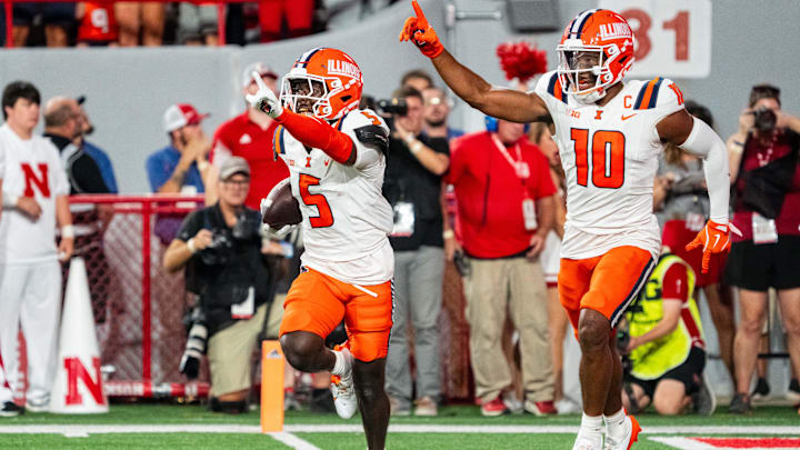Sep 20, 2024; Lincoln, Nebraska, USA; Illinois Fighting Illini defensive back Torrie Cox Jr. (5) and defensive back Miles Scott (10) celebrate after an interception in the end zone against the Nebraska Cornhuskers during the second quarter at Memorial Stadium.