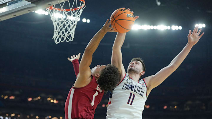 Apr 6, 2024; Glendale, AZ, USA; Connecticut Huskies forward Alex Karaban (11) blocks the shot of Alabama Crimson Tide guard Mark Sears (1) during the second half in the semifinals of the men's Final Four of the 2024 NCAA Tournament at State Farm Stadium. Mandatory Credit: Bob Donnan-Imagn Images