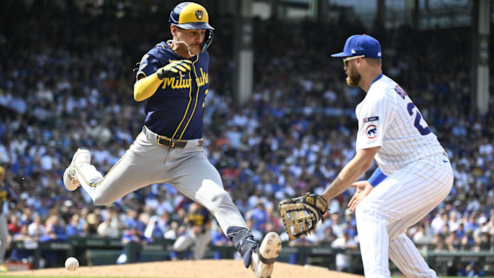 Aug 18, 2025; Chicago, Illinois, USA;   Milwaukee Brewers shortstop Joey Ortiz (3) makes it past Chicago Cubs first baseman Michael Busch (29) during the sixth inning  at Wrigley Field. Mandatory Credit: Matt Marton-Imagn Images