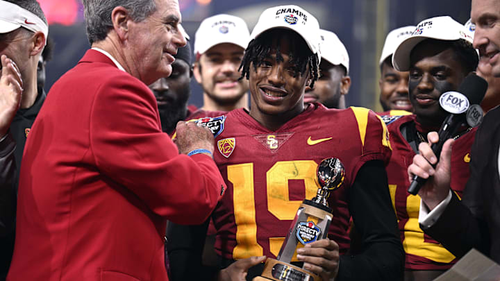 Dec 27, 2023; San Diego, CA, USA; USC Trojans safety Jaylin Smith (19) is presented the defensive MVP trophy after defeating the Louisville Cardinals at Petco Park. Mandatory Credit: Orlando Ramirez-Imagn Images