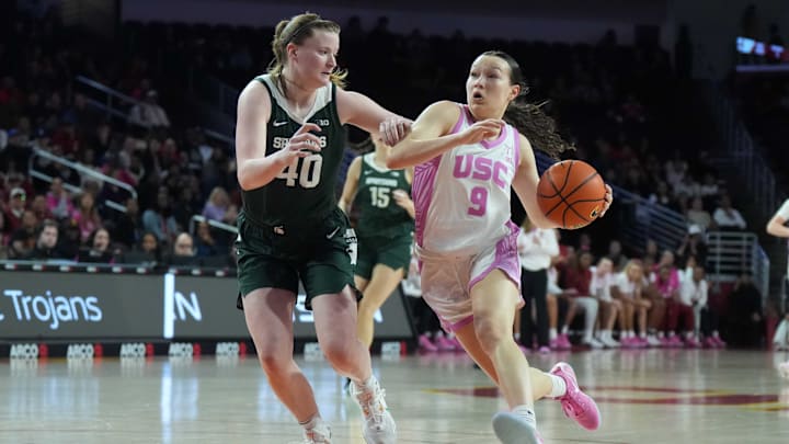 Feb 19, 2025; Los Angeles, California, USA; Southern California Trojans guard Kayleigh Heckel (9) dribbles the ball against Michigan State Spartans guard Julia Ayrault (40) in the first half at Galen Center. Mandatory Credit: Kirby Lee-Imagn Images Feb 19, 2025; Los Angeles, California, USA; Southern California Trojans guard Kayleigh Heckel (9) dribbles the ball against Michigan State Spartans guard Julia Ayrault (40) in the first half at Galen Center. Mandatory Credit: Kirby Lee-Imagn Images