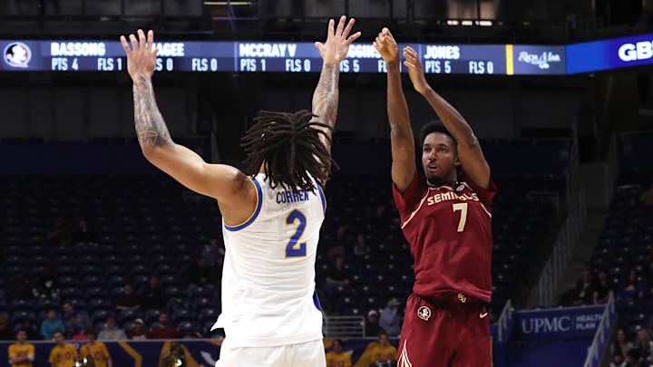 Mar 4, 2026; Pittsburgh, Pennsylvania, USA;  Florida State Seminoles forward Chauncey Wiggins (7) shoots a three point basket against Pittsburgh Panthers forward Cameron Corhen (2) during the first half at the Petersen Events Center. Mandatory Credit: Charles LeClaire-Imagn Images