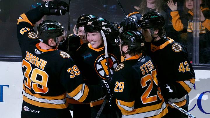 The celebrate Providence Bruins a second period score by teammate Providence forward Jimmy Lambert. The celebrate Providence Bruins a second period score by teammate Providence forward Jimmy Lambert.