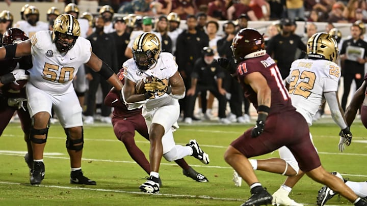 Sep 6, 2025; Blacksburg, Virginia, USA;  Vanderbilt Commodores running back Sedrick Alexander (28) runs the ball as Virginia Tech Hokies safety Tyson Flowers (11) defends during the fourth quarter at Lane Stadium. Mandatory Credit: Brian Bishop-Imagn Images