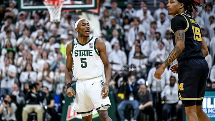 Michigan State's Tre Holloman, left, jaws at Michigan's Rubin Jones after scoring during the second half on Sunday, March 9, 2025, at the Breslin Center in East Lansing.