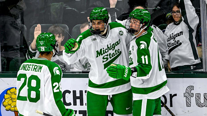 Michigan State's Gavin O'Connell, center, celebrates his goal with Cayden Lindstrom, left, and Owen West during the second period in the game against Notre Dame on Thursday, Feb. 19, 2026, at the Munn Ice Arena in East Lansing.