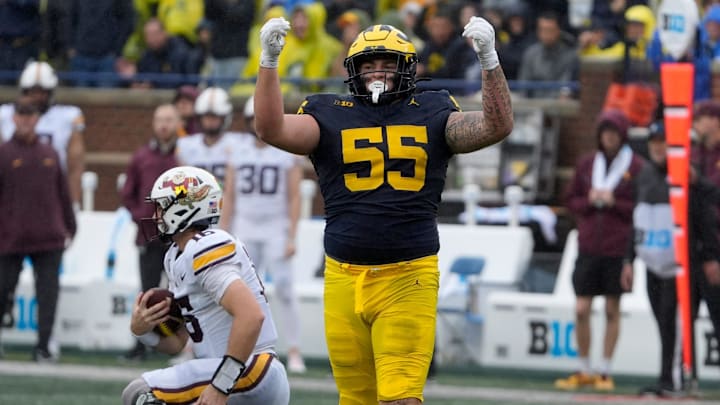 Michigan defensive lineman Mason Graham celebrates after sacking Minnesota quarterback Max Brosmer, in the background, during first-half action between Michigan and Minnesota at Michigan Stadium in Ann Arbor on Saturday, Sept. 28, 2024. Michigan defensive lineman Mason Graham celebrates after sacking Minnesota quarterback Max Brosmer, in the background, during first-half action between Michigan and Minnesota at Michigan Stadium in Ann Arbor on Saturday, Sept. 28, 2024.