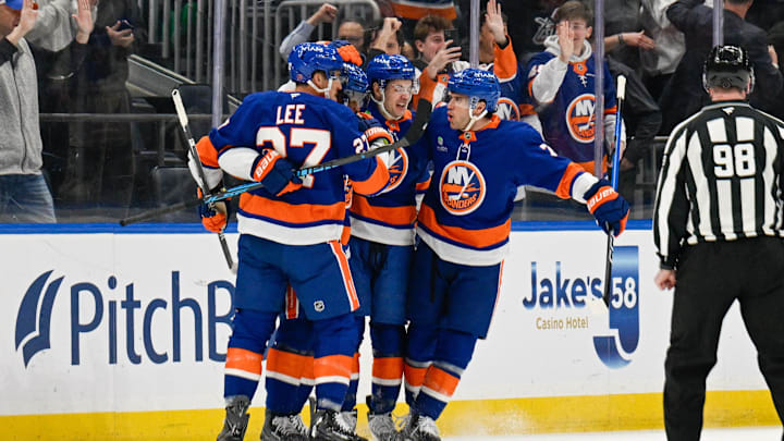 Jan 6, 2026; Elmont, New York, USA;  New York Islanders left wing Anders Lee (27), New York Islanders center Mathew Barzal (13) and New York Islanders defenseman Tony Deangelo (77) celebrate the goal byNew York Islanders left wing Anthony Duclair (11) against the New Jersey Devils during the first period at UBS Arena. Mandatory Credit: Dennis Schneidler-Imagn Images