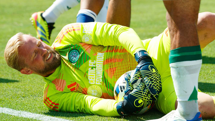 Celtic FC goalkeeper Kasper Schmeichel holds onto the ball after stopping an attack.