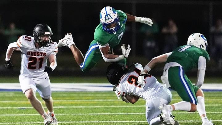 Green Bay Notre Dame's Kingston Allen (7) tries to leap over Kaukauna High School's Casen Vander Heiden (24) during a football game on Aug. 28, 2026, in Green Bay, Wis. Notre Dame defeated Kaukauna 35-28.