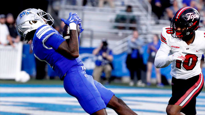 Middle Tennessee wide receiver Omari Kelly (1) catches a pass as Western Kentucky defensive back Jaymar Mundy (10) looks on during the rivalry football game at MTSU, on Saturday, Sept. 14, 2024.