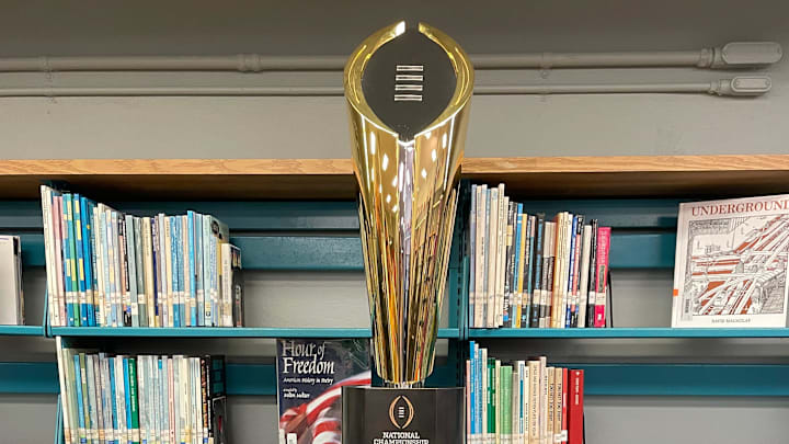 The College Football Playoff trophy is displayed at Miami's Brownsville Middle School for a news conference on April 10, 2025.