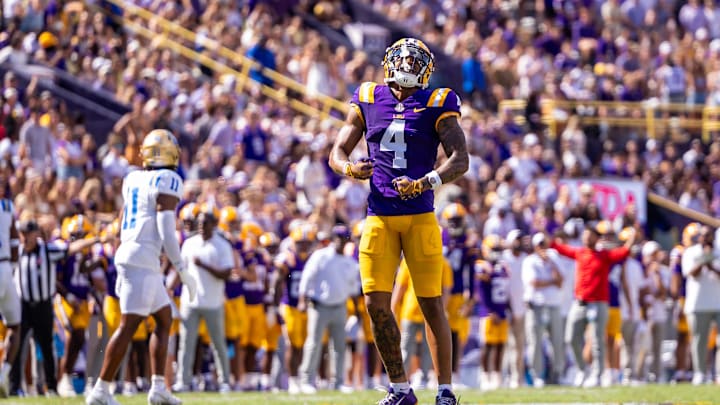 Sep 21, 2024; Baton Rouge, Louisiana, USA; LSU Tigers wide receiver CJ Daniels (4) reacts after missing a pass against UCLA Bruins defensive back Ramon Henderson (11) during the first half at Tiger Stadium. Mandatory Credit: Stephen Lew-Imagn Images Sep 21, 2024; Baton Rouge, Louisiana, USA; LSU Tigers wide receiver CJ Daniels (4) reacts after missing a pass against UCLA Bruins defensive back Ramon Henderson (11) during the first half at Tiger Stadium. Mandatory Credit: Stephen Lew-Imagn Images
