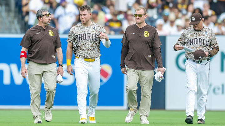 Jun 1, 2025; San Diego, California, USA; San Diego Padres left fielder Gavin Sheets (30) walking off the field with manager Mike Shildt (8) and training staff during the fourth inning against the Pittsburgh Pirates at Petco Park. Mandatory Credit: David Frerker-Imagn Images Jun 1, 2025; San Diego, California, USA; San Diego Padres left fielder Gavin Sheets (30) walking off the field with manager Mike Shildt (8) and training staff during the fourth inning against the Pittsburgh Pirates at Petco Park. Mandatory Credit: David Frerker-Imagn Images