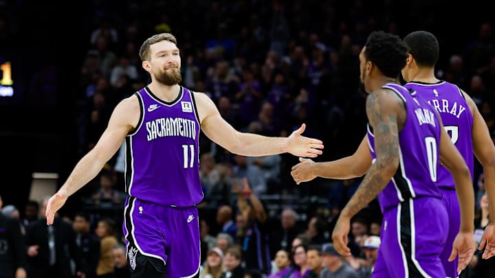 Jan 22, 2025; Sacramento, California, USA; Sacramento Kings forward Domantas Sabonis (11) shakes hands with forward Keegan Murray (13) during the fourth quarter against the Golden State Warriors at Golden 1 Center. Mandatory Credit: Sergio Estrada-Imagn Images