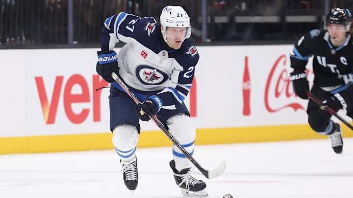 Jan 20, 2025; Salt Lake City, Utah, USA; Winnipeg Jets left wing Nikolaj Ehlers (27) skates with the puck against the Utah Hockey Club during the third period at Delta Center. Mandatory Credit: Rob Gray-Imagn Images