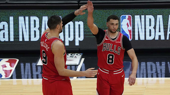 Chicago Bulls guard Zach LaVine (8) celebrates his three point basket against the Boston Celtics with center Nikola Vucevic (9) during the second half at United Center. Mandatory Credit: David Banks-Imagn Images