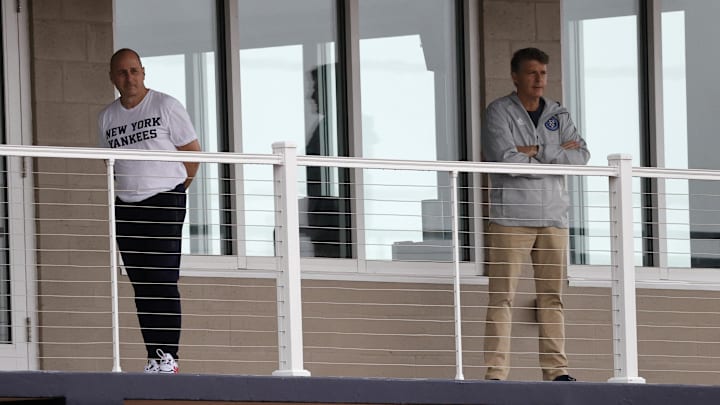 Tampa, Florida, USA; New York Yankees general manager Brian Cashman and owner Hal Steinbrenner look on during spring training workouts at Yankees Players Development Complex.