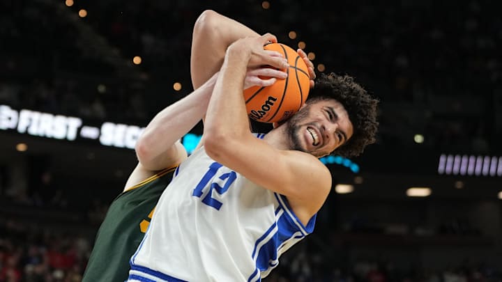 Mar 19, 2026; Greenville, SC, USA; Duke Blue Devils forward Cameron Boozer (12) gets a rebound against Siena Saints center Riley Mulvey (55) in the first round of the NCAA Tournament.