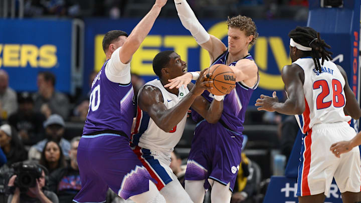 Nov 5, 2025; Detroit, Michigan, USA; Detroit Pistons center Jalen Duren (0) is fouled by Utah Jazz center Jusuf Nurkic (30) and forward Lauri Markkanen (23) while driving to the basket in the first quarter at Little Caesars Arena. Mandatory Credit: Lon Horwedel-Imagn Images
