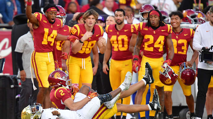 Nov 30, 2024; Los Angeles, California, USA; Southern California Trojans wide receiver Duce Robinson (2) catches a pass against Notre Dame Fighting Irish safety Rod Heard II (2) during the second half at the Los Angeles Memorial Coliseum. Mandatory Credit: Gary A. Vasquez-Imagn Images Nov 30, 2024; Los Angeles, California, USA; Southern California Trojans wide receiver Duce Robinson (2) catches a pass against Notre Dame Fighting Irish safety Rod Heard II (2) during the second half at the Los Angeles Memorial Coliseum. Mandatory Credit: Gary A. Vasquez-Imagn Images